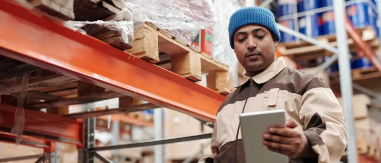 E-commerce warehouse representative looking at last mile delivery checklist | Locad