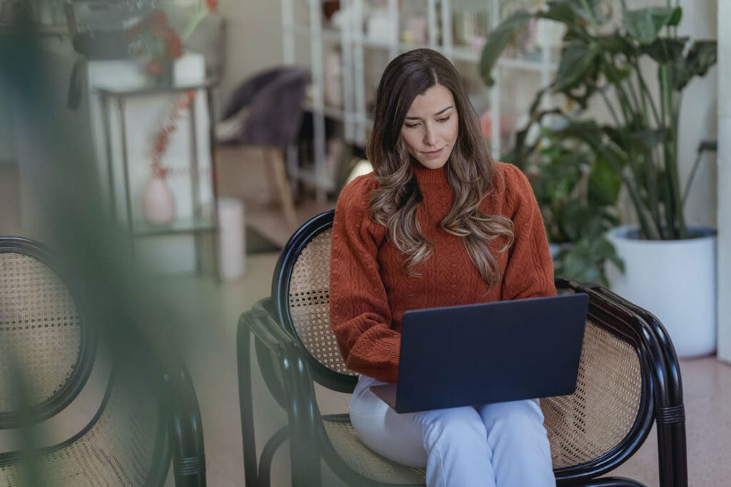 woman e-commerce business owner typing on her laptop